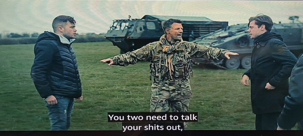 A soldier tells two men arguing that they need to talk their shit out, but the subtitles incorrectly have him telling them to talk their shits out.