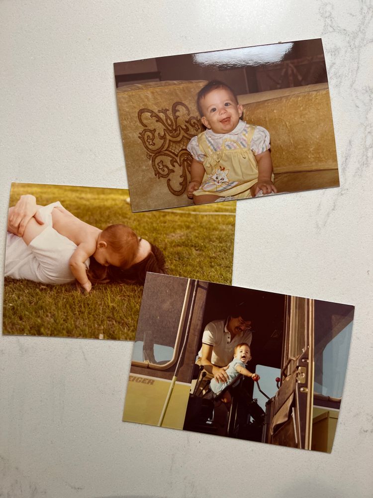 Three photos of a baby, one in a yellow dress, sitting on a yellow couch, one being cradled by her mother who is laying in the grass, and another being assisted in playing with the gears of a tractor by her father with a very 70s mustache. 