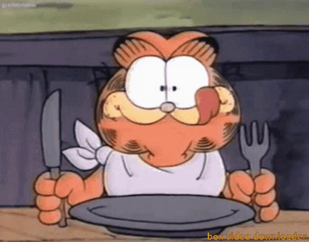 garfield is holding a knife and fork in front of an empty plate