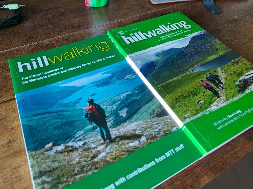 Two copies of a green book, both titled "Hillwalking". The one on the right is thicker than the one on the left.