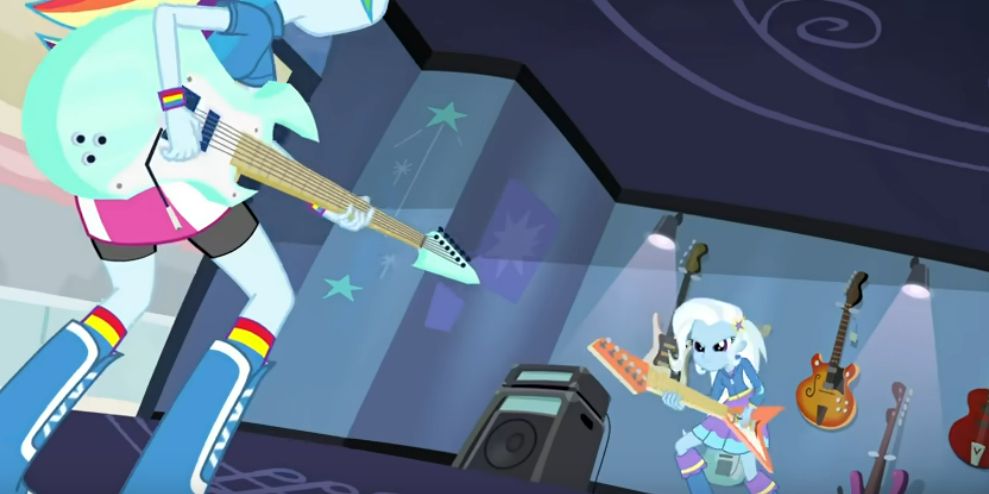 Human raninbow dash is playing a cyan guitar, while Trixie plays a flying V style guitar left-handed