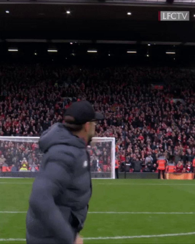 a man stands on a soccer field in front of a crowd with lfctv written on the bottom