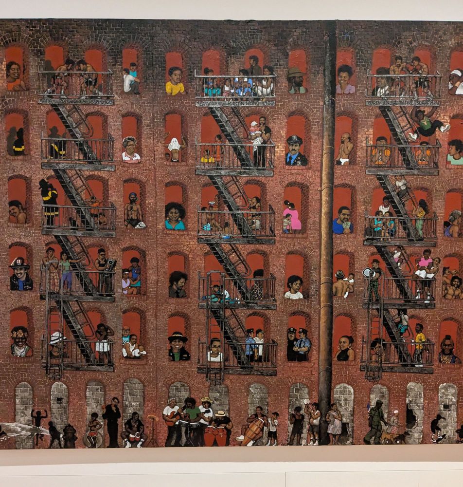 "La Vida," a painting of many people in the windows on the fire escapes of a brick apartment building, by Martin Wong 