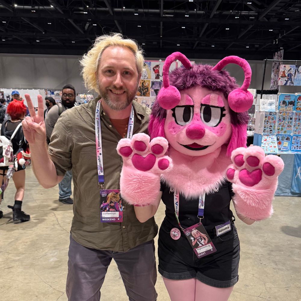 me posing with bignosebug in her mascot costume 