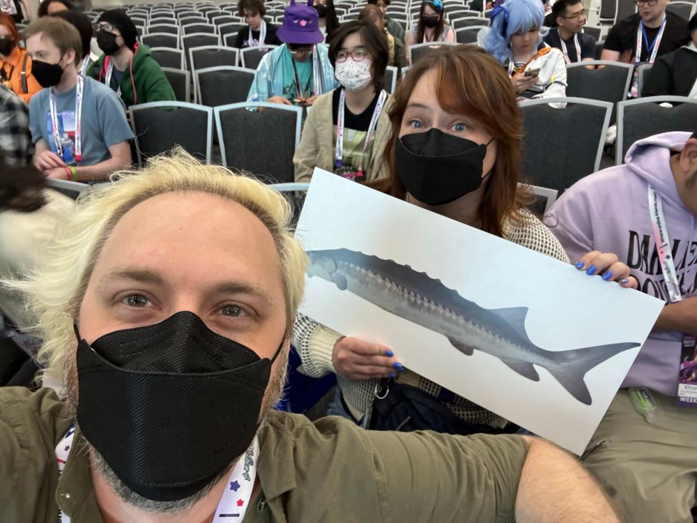 me & mac holding a joel foam board sign at the shindigs panel