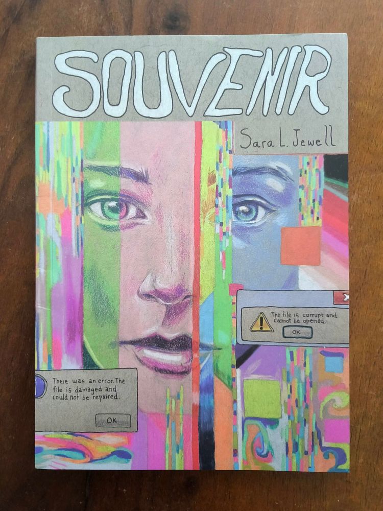 The cover of Sara L. Jewell's graphic novel SOUVENIR published by Fieldmouse Press.
The cover shows a drawing of a young person's face with vunlnerable eyes looking at the viewer. The drawing is done in colored pencil with shifting colours of pink, green, blue and "glitch-like" effects.