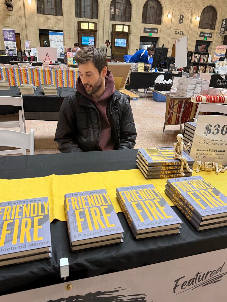 Me nonchalantly looking off to the side sitting at my booth the day before the book fest