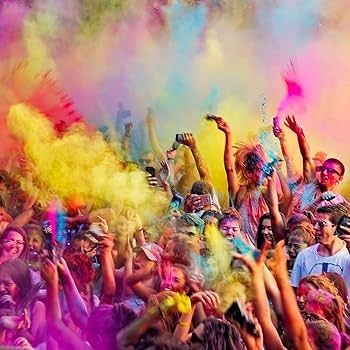 People are covered in colored powder.