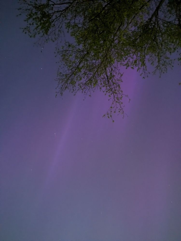The night sky in Ohio with some purple aurora visible