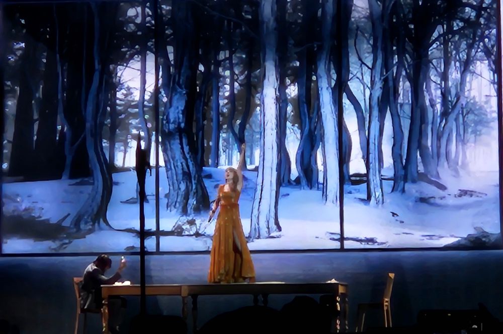 Taylor Swift on top of a prop table performing tolerate it on the Eras Tour 