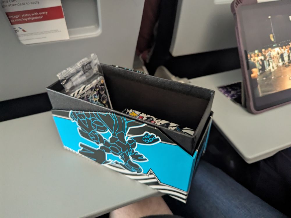 open Black Bolt etb sitting on the airplane tray table