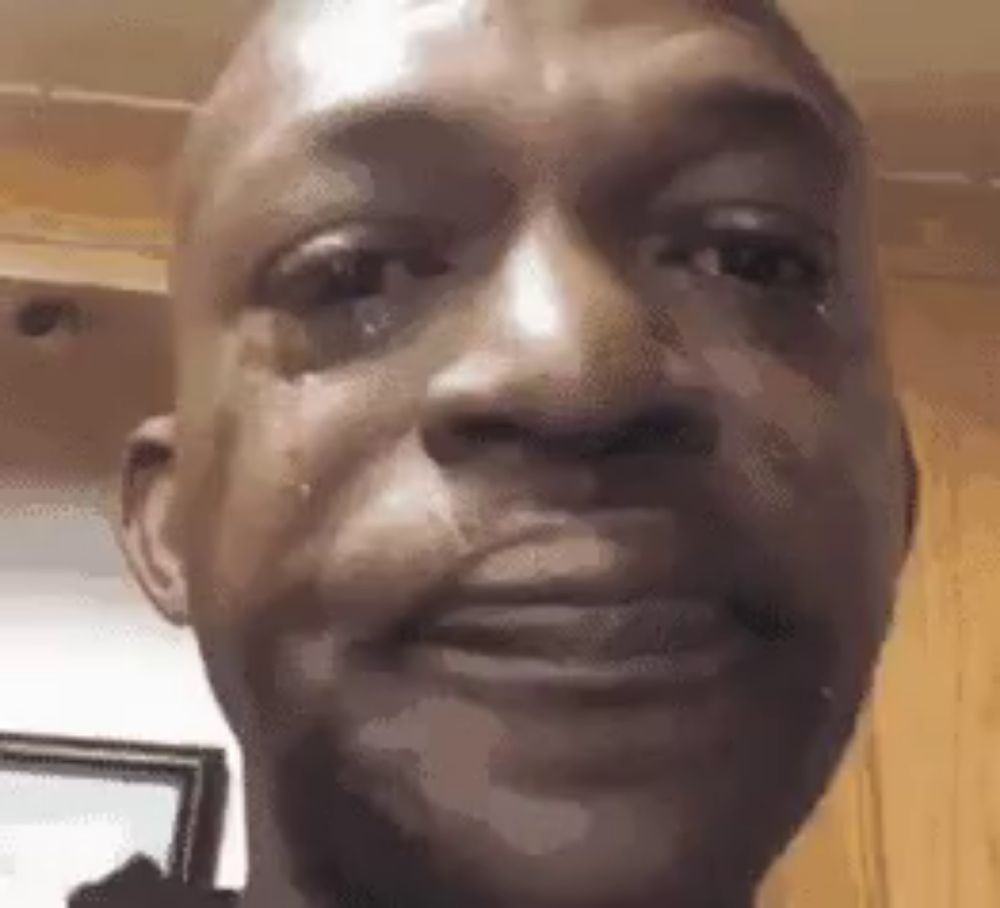 a close up of a man 's face with a tear running down his face .