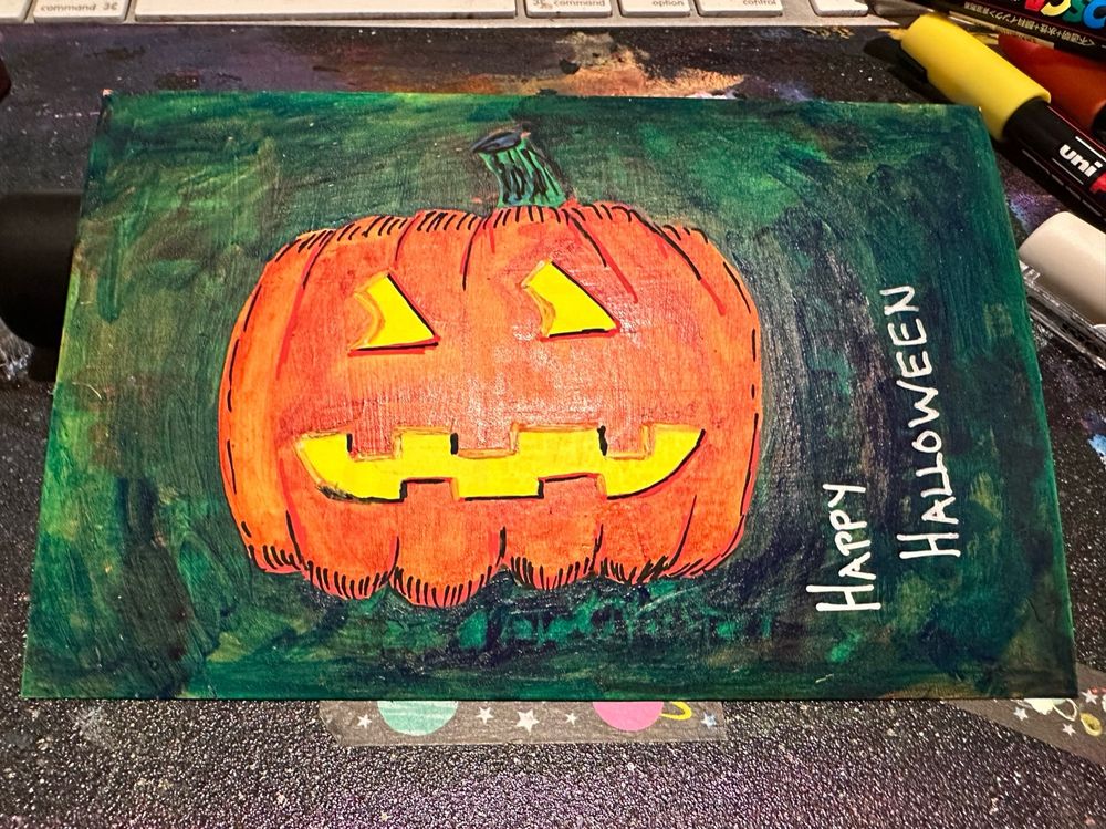Painting of a jack-o’-lantern with the words happy Halloween. 