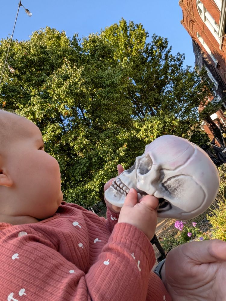 Baby and plastic skull.