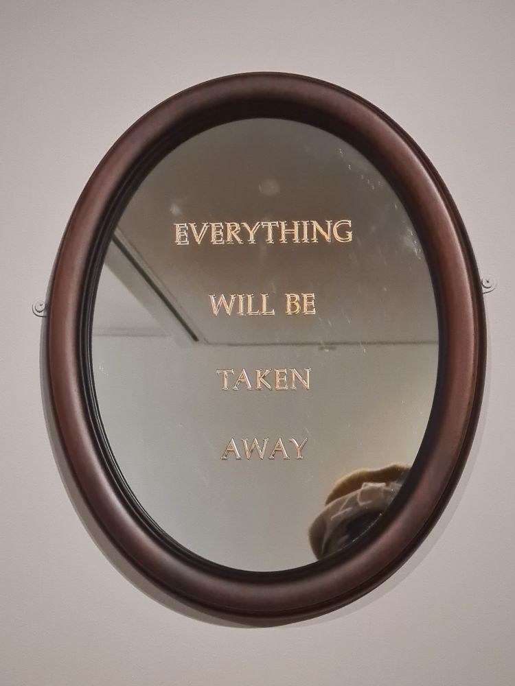Mirror with gold leaf engraved text 
EVERYTHING WILL BE TAKEN AWAY in mahogany frame