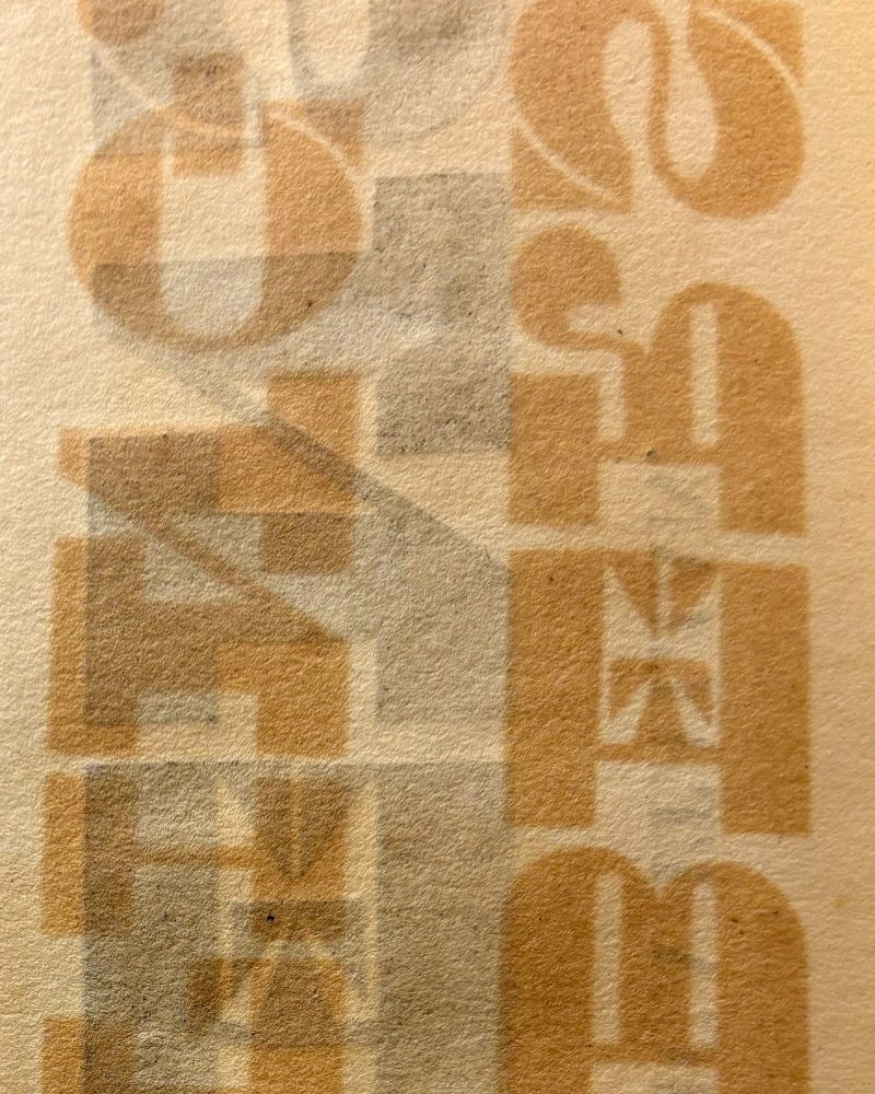 Overlapping typographic forms from 1827 George Bruce specimen catalog. Cream colored stock with high contrast tonal value letterforms.