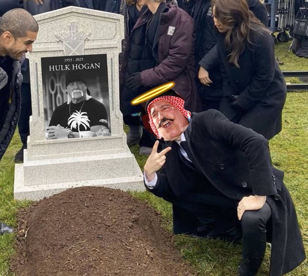 A meme of The Iron Sheik crouching and flashing a piece sign in front of a grave, mocked up to show Hulk Hogan as the person buried there. Sheik has a halo over his head. 