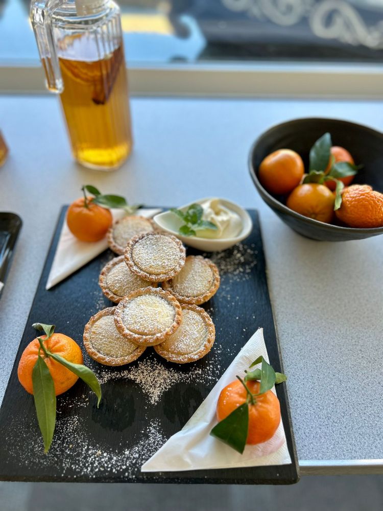Mince pies and clementines laid out on a tray looking perfectly festive