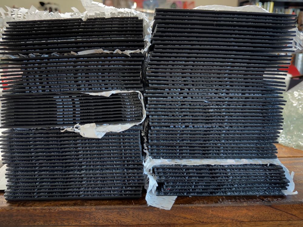 A stack of a hundred hueforge prints 
