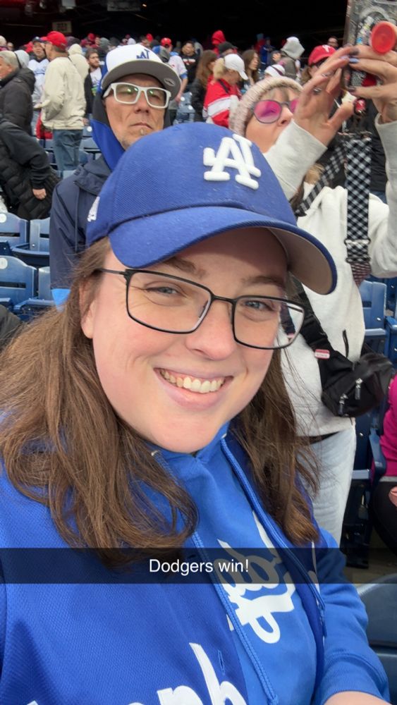 A selfie in Dodgers sweatshirt and hat, with the caption “Dodgers win!”