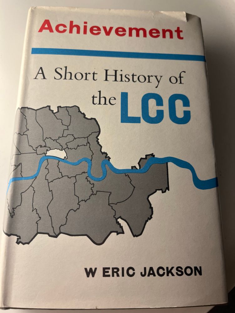 Book titled:
A Short History of the LC C
W ERIC JACKSON
White background with grey outline of inner London boroughs with blue river Thames running through the middle