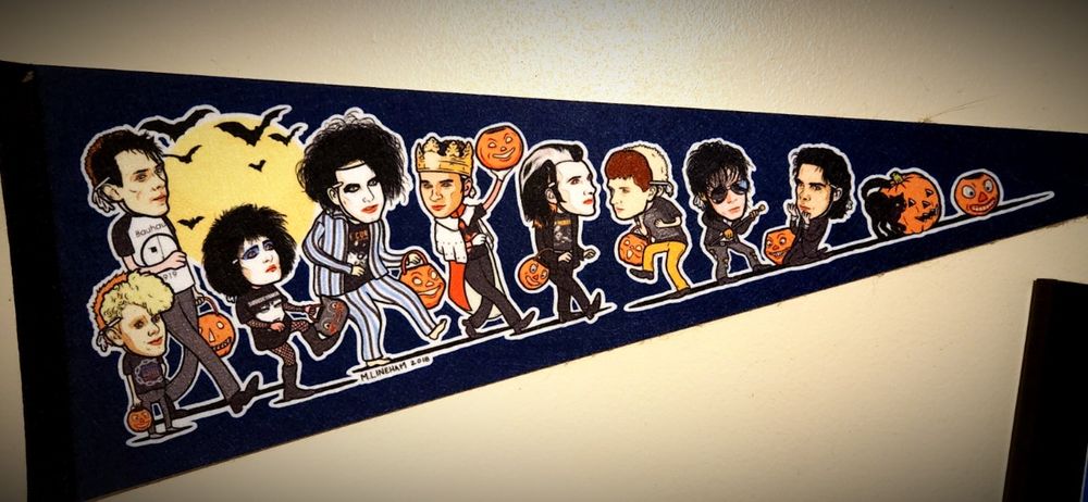 A pennant featuring artistic renderings of classic goth and darkwave musicians like Peter Murphy, Siouxsie Sioux, the Damned, Nick Cave, and others.