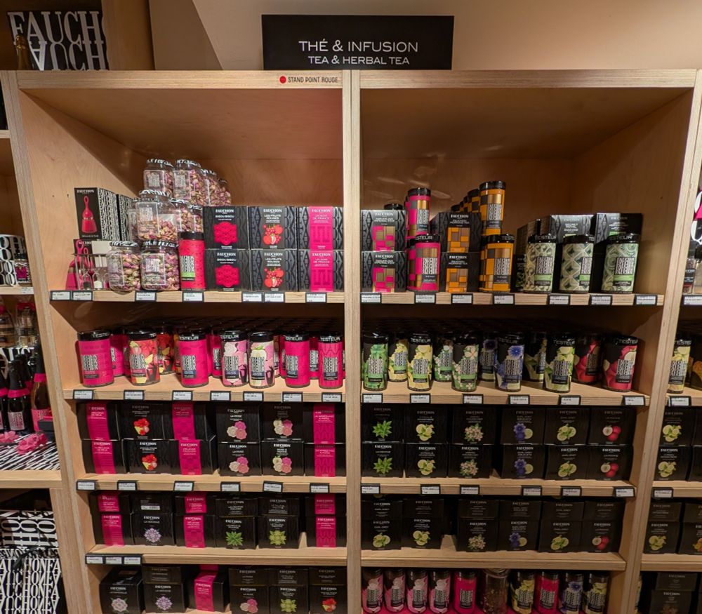 A wall of tea in a Department store. All kinds, in all sizes of containers. 