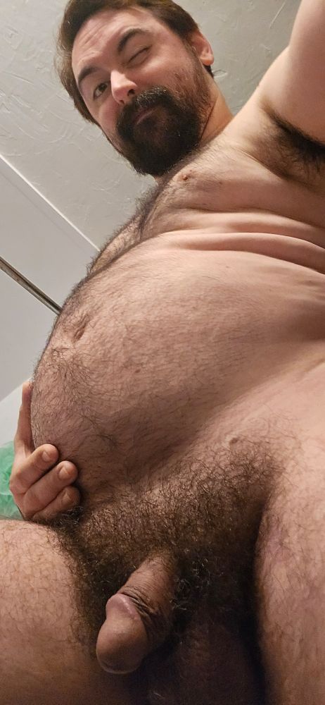 The pup winking down at the viewer, soft cock slinking out of the bush. The fuzzy tummy could use some rubbing!