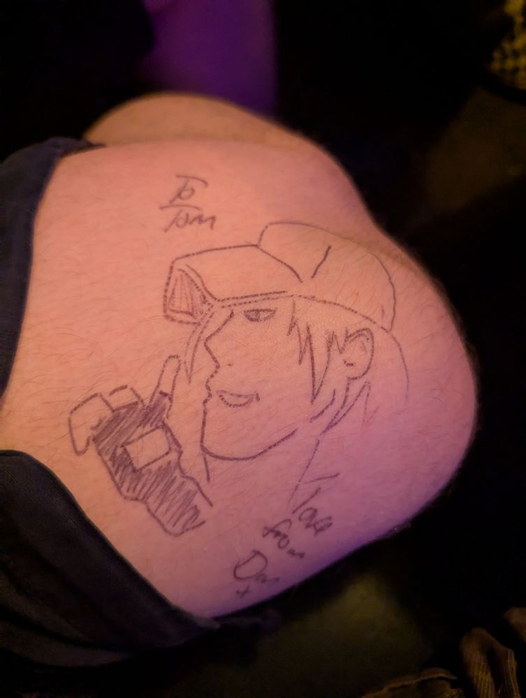 A dreadful drawing of Terry Bogard on a man's knee. The text reads "To Tom, love from Dan"