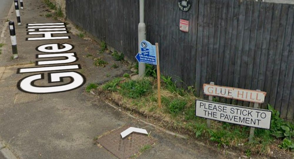 A street sign for Glue Hill. Underneath there is another sign reading "PLEASE STICK TO THE PAVEMENT"