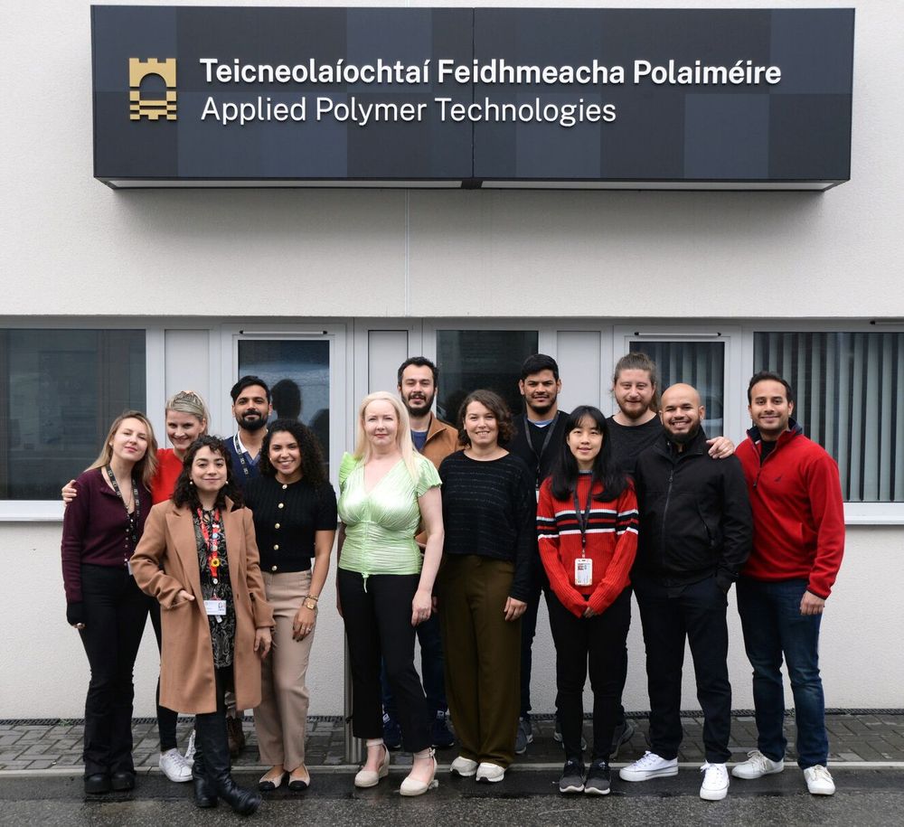 Uma foto de grupo de pesquisadores na Technological University of the Shannon (TUS), liderada pela Dra. Margaret Brennan Fournet. A equipe é composta por 14 membros, com um equilíbrio igualitário entre pesquisadoras e pesquisadores, especialistas em diversas áreas como química, ciência dos materiais, microbiologia e biotecnologia.