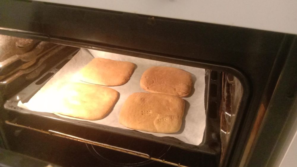 nicely tanned cake layers sitting in the oven as i peek through the oven's door to assess their condition