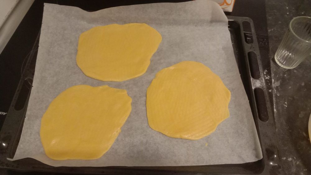 my best attempts at circles by just rolling 1/6 of the dough out. needless to say it came out all wonky and all over the place. thankfully it's dough so i could redo it over and over