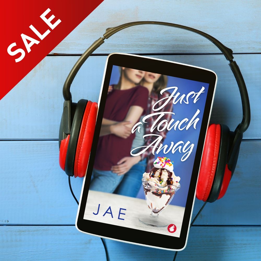 Shown is the cover of Just a Touch Away by Jae--two women embracing, with an ice cream bowl and sprinkles in front of them. The cover is wearing headphones. Next to the cover are the words "audiobook sale."