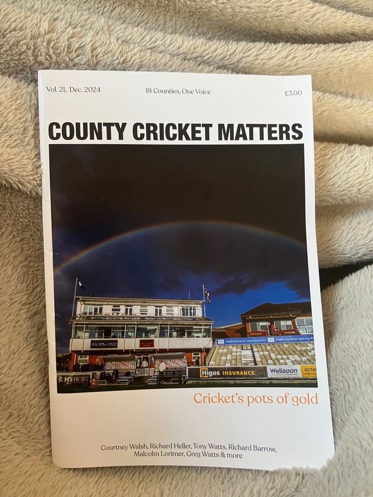The cover of Count Cricket Matters issue 21. The first photo is of a rainbow above a cricket pavilion.
