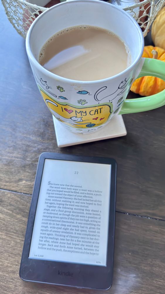 Mug with coffee and kindle book