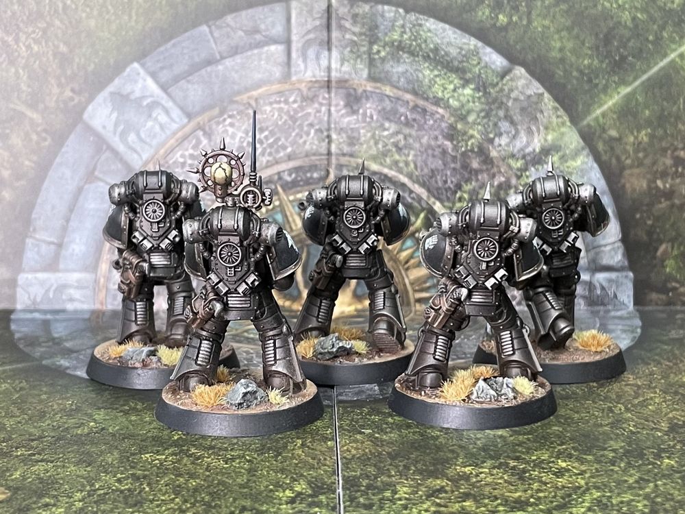 A rear view of 5 Iron Hands space marines in Mk 3 armour. You can see the chunky power packs and details of the comm-array.