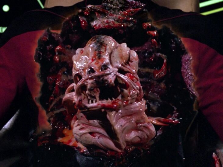 A creepy little worm guy, a pink and bloody parasite in the burned out chest cavity of a Starfleet officer from Star Trek: The Next Generation. Is it screaming with an angler fish mouth or smirking with little dark lips, idk, he’s a creepy parasite, but NOT a Trill. Those are good worms. This is a BAD worm.