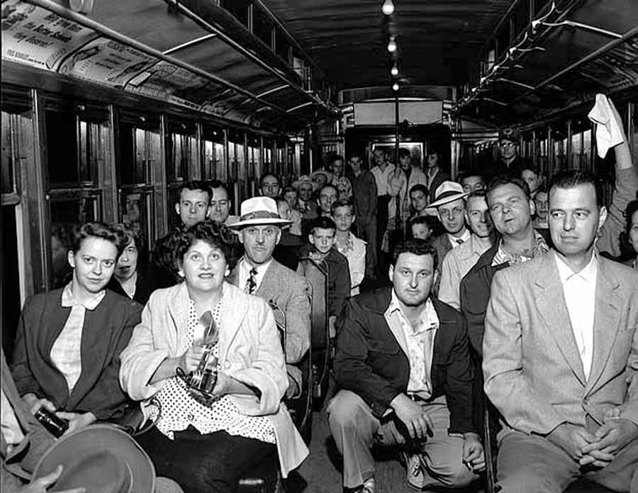 A Twin Cities Rapid Transit streetcar is packed with passengers, some holding cameras. Minnesota Streetcar Museum.