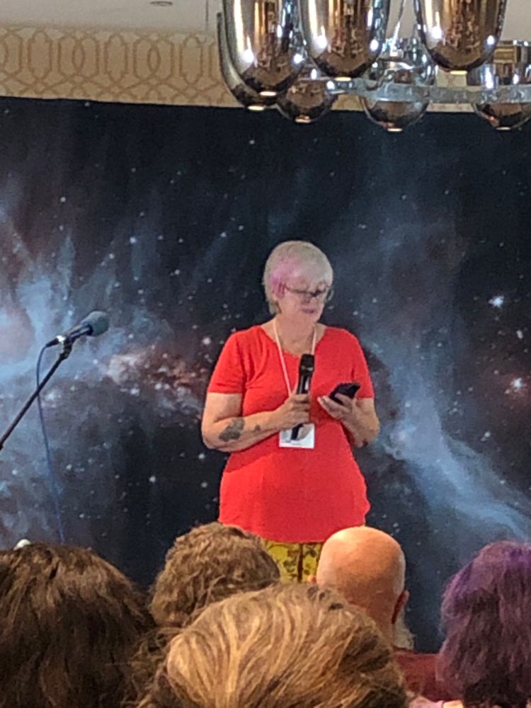 Cat Rambo on stage with microphone