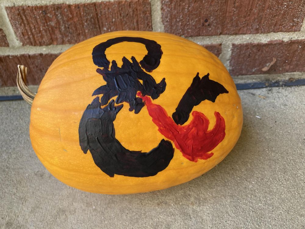 Pumpkin painted with a D&D-style dragon-shaped ampersand