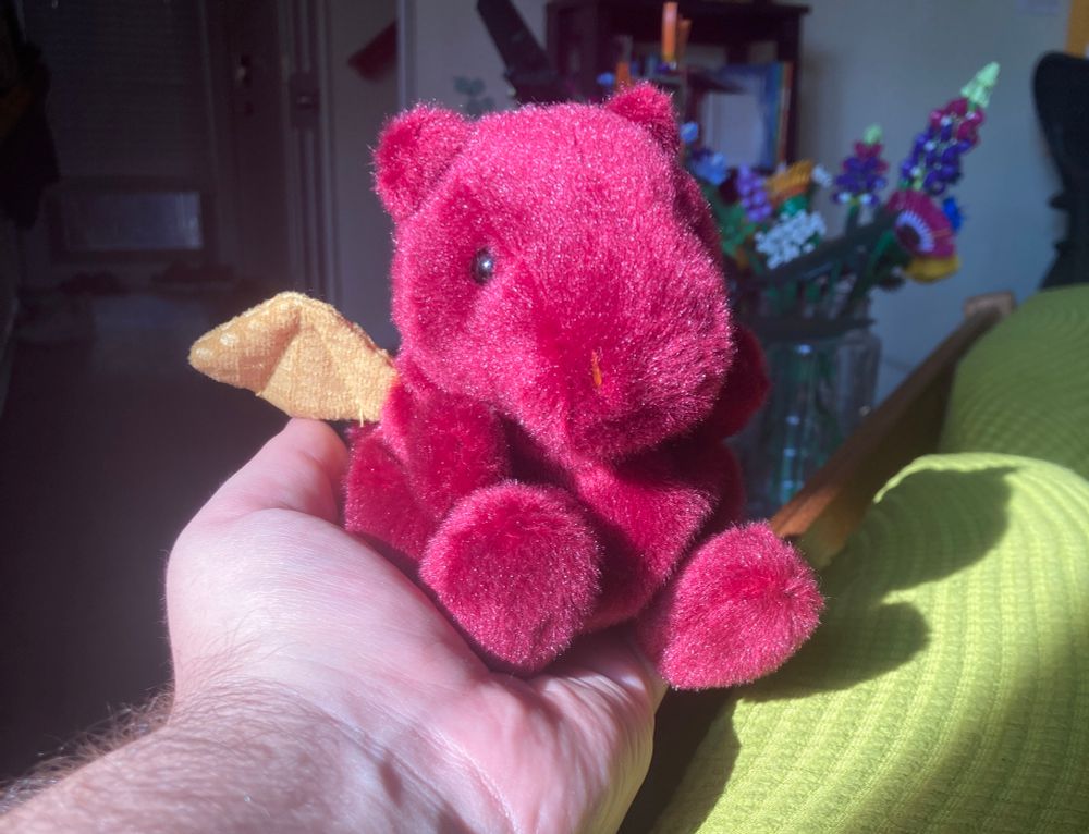 A palm pal, red dragon with gold wings