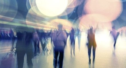 A blurry image of a crowd of people in motion