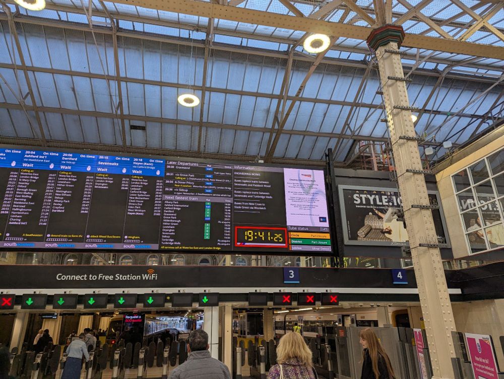 Wide shot of the same image, includes the station roof and a glimpse of the platforms