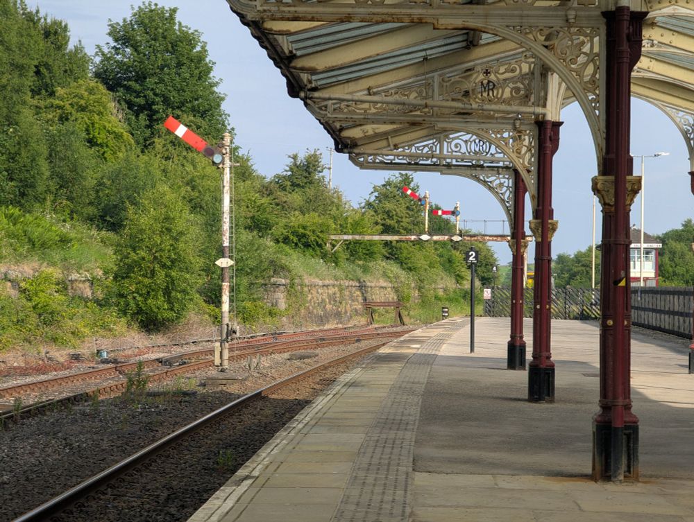 Cream and red canopy to the right, semaphore signals to the left and centre