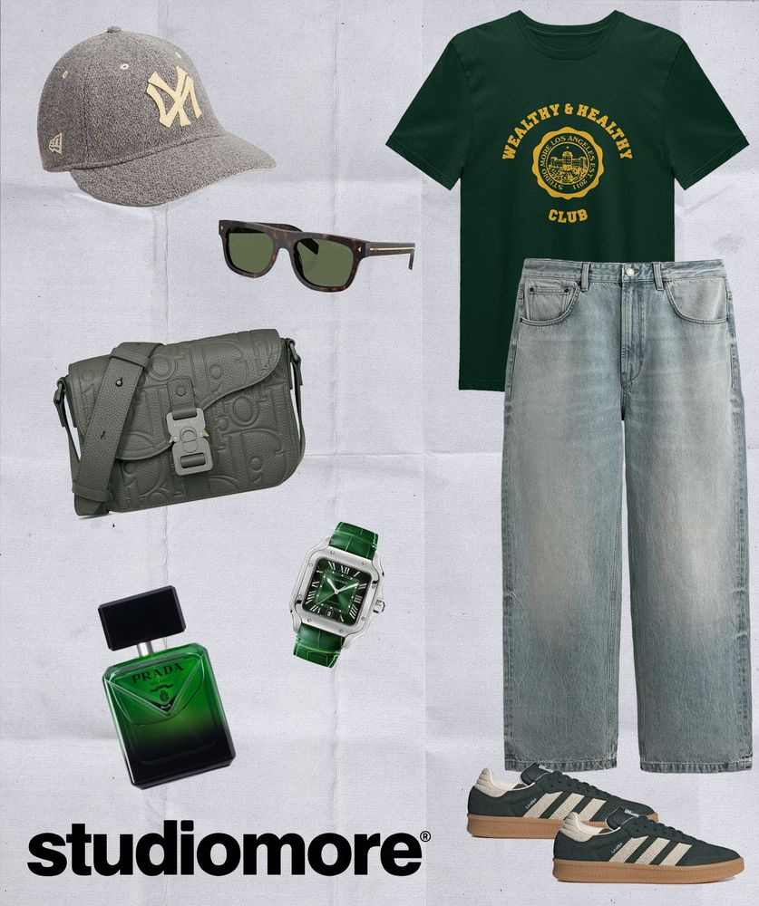 A streetwear flatlay featuring the Studio More Wealthy & Healthy Club Tee in forest green paired with grey denim, Green samba Adidas sneakers, a Dior Small Saddle Messenger bag, Prada Paradigme Eau de Parfum fragrance, a Cartier Santos watch with a green croc leather strap, Prada tortoiseshell sunglasses, and a grey Polo Ralph Lauren Yankees Wool-Blend Cap.