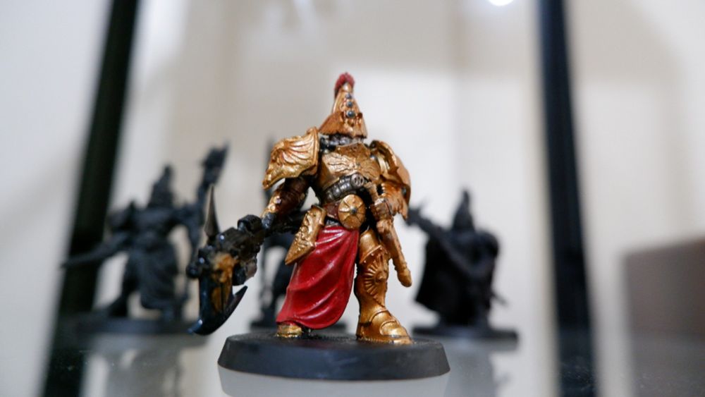 A miniature of a warhammer 40k Custodes 