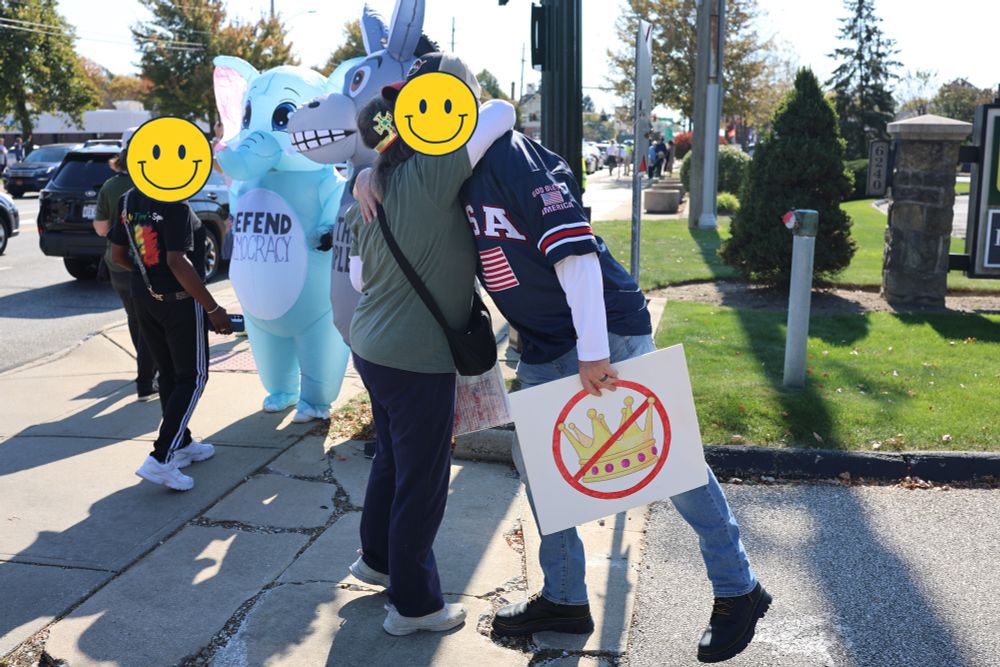 east suburb of cleveland
no kings rally
two people hug each other. one holds a no kings sign.