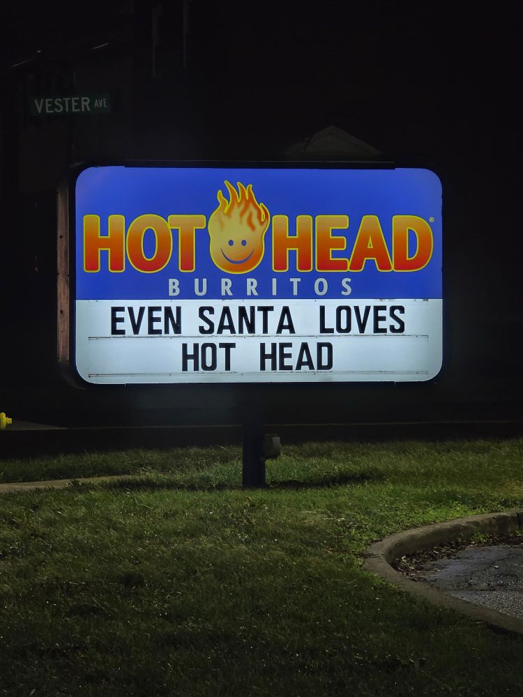 Sign outside Hot Head Burritos reads Even Santa Loves Hot Head