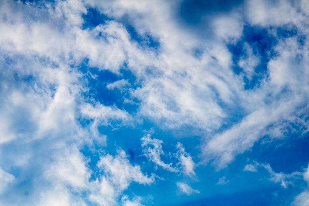 Very wispy clouds against the bright blue sky.